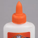 An Elmer's Glue-All 4 oz. white plastic bottle with an orange cap.
