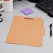 A brown Pendaflex file folder on a desk.