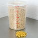 A translucent Cambro round polypropylene food storage container with pasta inside.