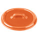 An orange Bon Chef porcelain oval cocotte lid with a handle.