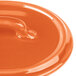 An orange Bon Chef oval cocotte lid with a handle.