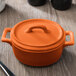 The orange Bon Chef oval lid for a small casserole dish.