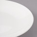A close-up of a Bon Chef white porcelain bread and butter plate with a thin rim.