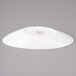 A white porcelain slanted oval bowl with red text on it.