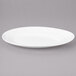 A white Bon Chef porcelain plate with a slanted oval shape.