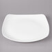 A white square Bon Chef porcelain dinner plate with a curved edge.