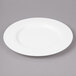 A white Bon Chef bone china salad plate with a wide rim.
