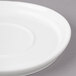 A close-up of a white Bon Chef porcelain saucer with a small rim.