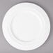 A Bon Chef white porcelain charger plate with a rim.