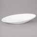 A white oval bowl with a slanted edge.