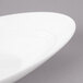A white porcelain bowl with a slanted oval shape.