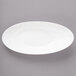 A white porcelain oval bowl with a curved edge.