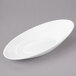 A white oval porcelain bowl with a thin rim.