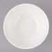 A white bowl with a circular design on a white surface.