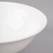 A white Bon Chef porcelain bowl with a rim on a white surface.