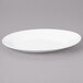 A white Bon Chef porcelain oval plate with a rim.