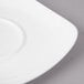 A close-up of a white Bon Chef porcelain saucer with a small rim.