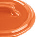 The orange Bon Chef porcelain lid with a handle.