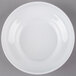 A white melamine bowl with a white rim on a gray background.