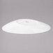 A white slanted oval porcelain bowl with a red rim.