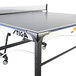 A Stiga ping pong table with a blue and black top and a net on it.