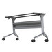 A grey metal Safco Flip-n-Go table base with wheels.