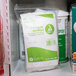 A white and green package of Medi-First Triangle Bandage with Pins on a shelf.