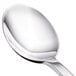 A close-up of a Walco stainless steel dessert spoon with a silver handle.