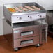 A Cooking Performance Group heavy-duty stainless steel gas countertop griddle with food on it.