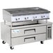 A Cooking Performance Group stainless steel chef station with a large grill over two refrigerated drawers.