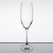A close-up of a clear Libbey Contour champagne flute on a reflective surface.