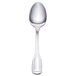 A Walco Luxor stainless steel demitasse spoon with a silver handle.