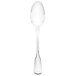 A Walco Luxor stainless steel serving spoon with a white handle on a white background.