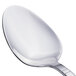 A close-up of a Walco stainless steel serving spoon with a silver handle.