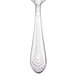 A Walco stainless steel demitasse spoon with a silver design on the handle.