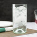A Libbey Spanish Green wine bottle tumbler filled with ice on a table