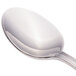 A close-up of a Walco Pacific Rim stainless steel demitasse spoon with a silver handle.