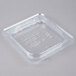 A Carlisle clear polycarbonate hinged lid on a clear plastic container.