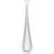 A Walco stainless steel teaspoon with a white handle and silver spoon.