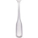 A close-up of a Walco stainless steel dessert spoon with a clear glass handle.