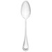 A Walco stainless steel serving spoon with a silver handle on a white background.