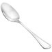 A Walco Lisbon stainless steel serving spoon with a silver handle.