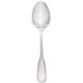 A Walco stainless steel tablespoon with a silver handle.