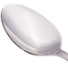 A close-up of a Walco Saville stainless steel serving spoon with a silver handle.