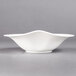 A Villeroy & Boch white porcelain deep bowl with a curved edge on a gray background.