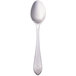 A Walco stainless steel dessert spoon with a design on the handle.