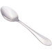 A close-up of a stainless steel Walco Meteor dessert spoon with a white handle.