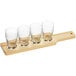 An Acopa wooden flight paddle with four Barbary tasting glasses on it.