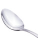 A close-up of a Walco stainless steel spoon with a silver handle.