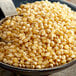 A bowl of Reist HI-POP Organic Butterfly Popcorn kernels.